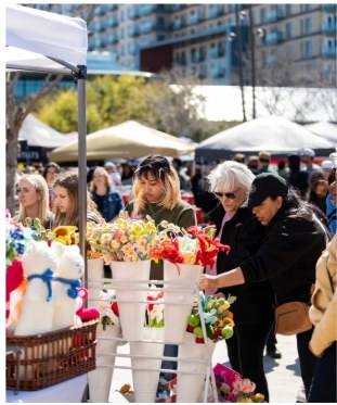 Guests shopping at a curated outdoor vendor market